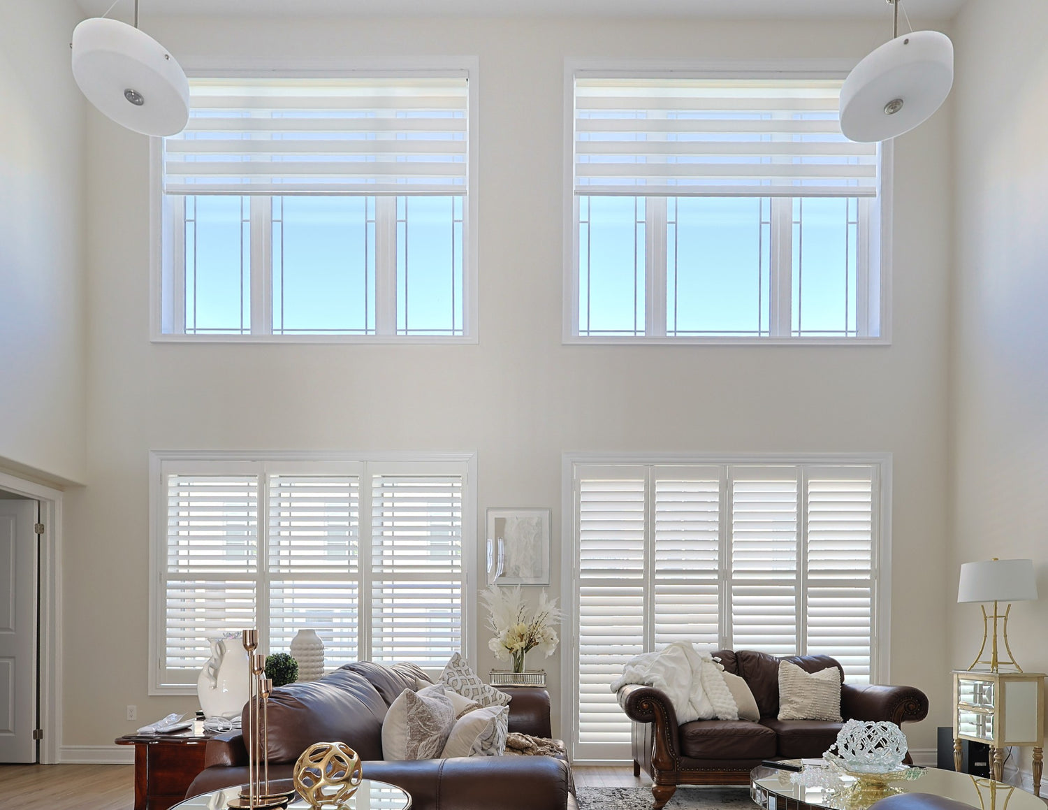 Custom blinds covering windows in a two-storey living room