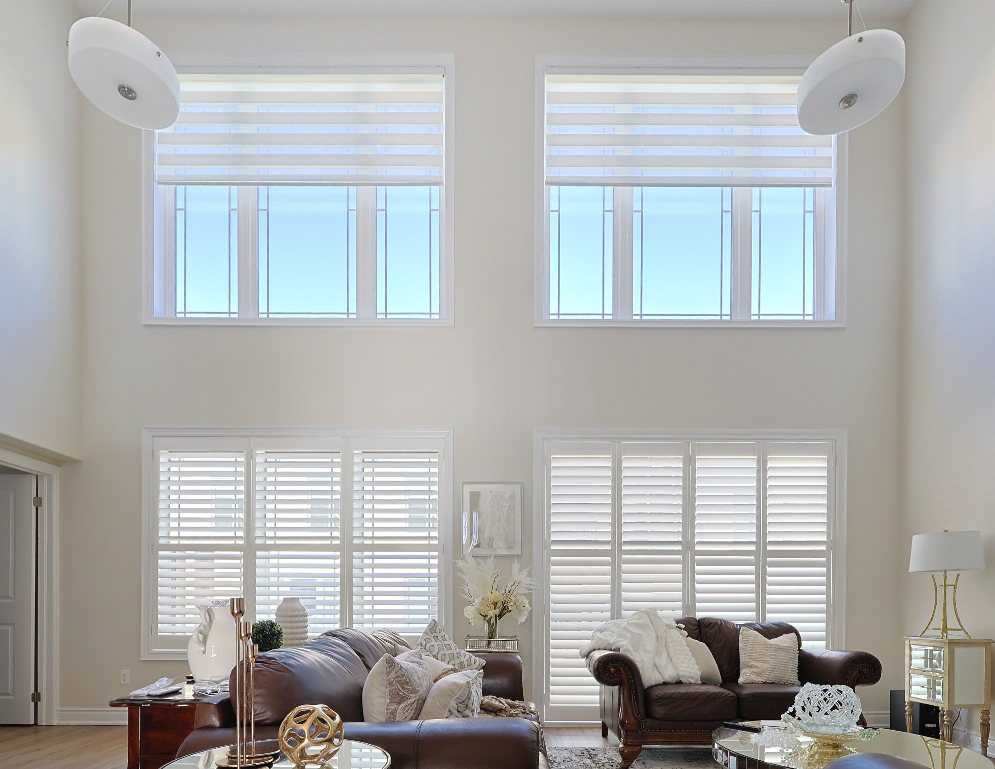Custom blinds covering windows in a two-storey living room