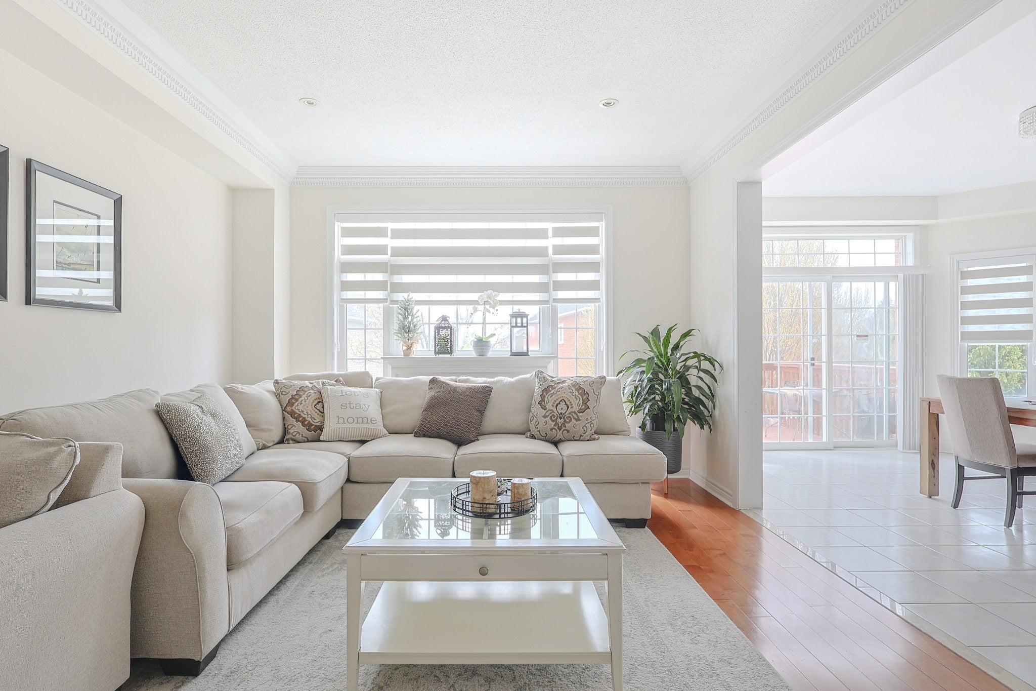 Zebra blind installed above a neutral living-room sofa