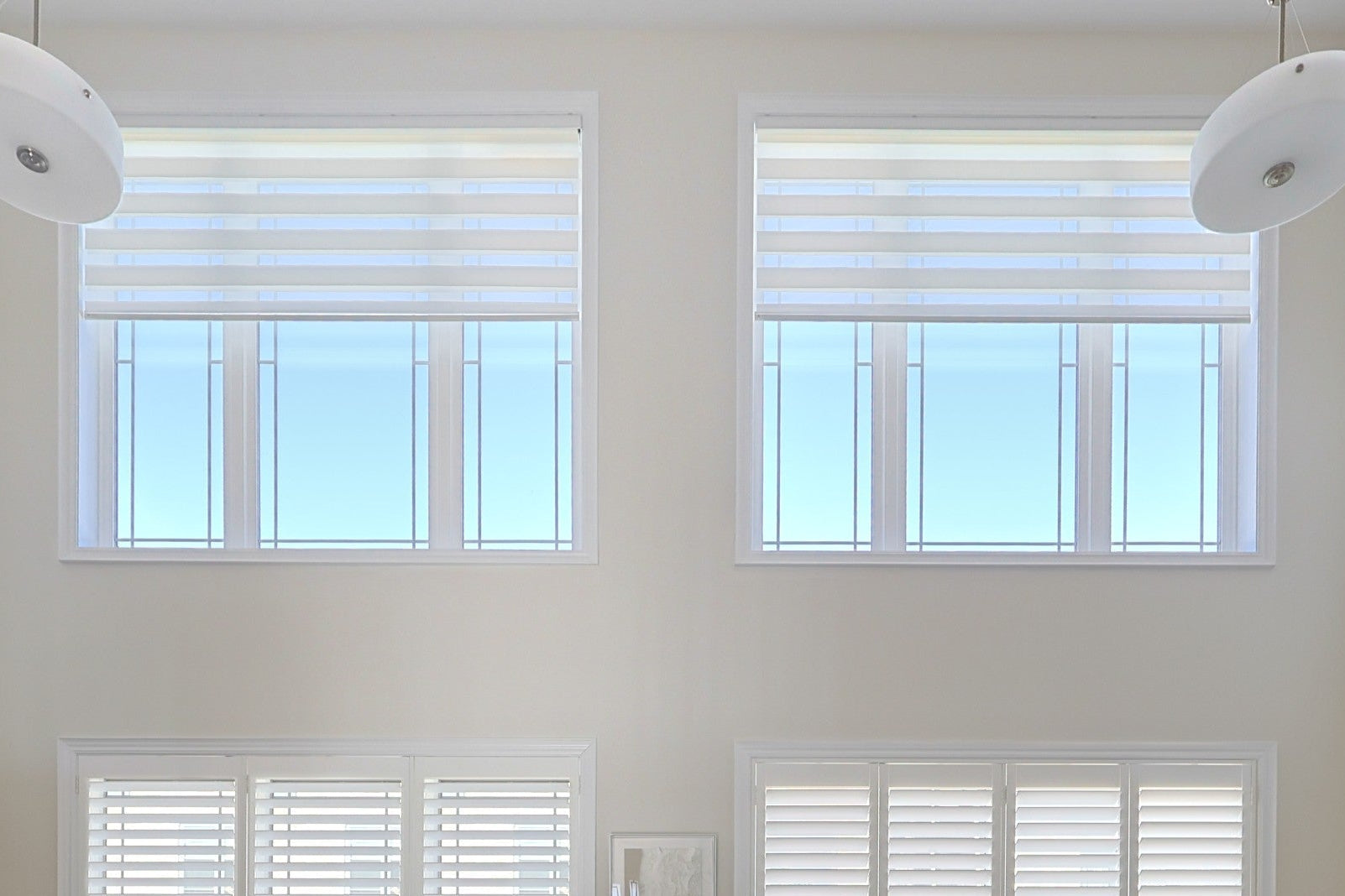 White zebra blinds installed across two large windows
